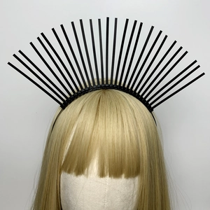 Close-up of black spiked halo crown headband with zipper detail on golden hair