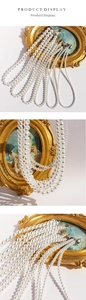 Close-up of layered white crystal pearl necklaces with vintage gold clasp details