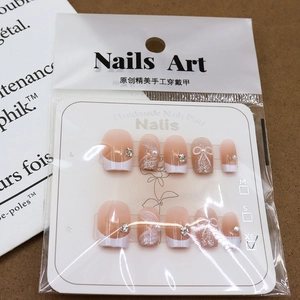 Handmade press-on nails with 3D bows, pearls, and rhinestones in soft pink French style