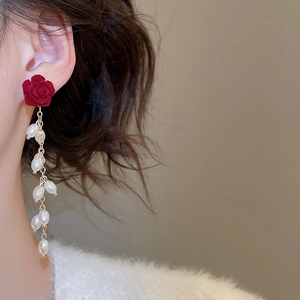 Detail of red rose stud with white baroque pearl tassels on a vintage earrings model