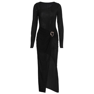 Detailed view of the black dress featuring a gold metal buckle and pleated waist design