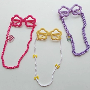 Star-shaped children sunglasses with colorful decorative chains in pink, yellow, and purple