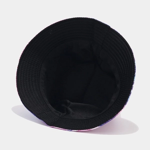 Macro view of reversible bucket hat showing colorful tie-dye print and black interior
