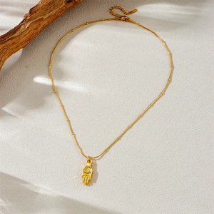 Vintage gold-plated Hamsa Hand and eye pendant necklace on a bead bamboo chain