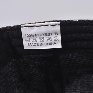 Detail view of the 100% polyester fabric label and inner lining of the baseball cap