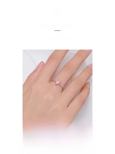 Detailed close-up of a minimalist S925 silver ring featuring a pink teardrop opal stone