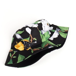 Close-up of floral bucket hat with bird print, black cotton fabric, and reinforced brim stitching