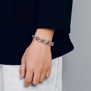 Polished silver stainless steel thick link chain bracelet shown on a wrist for unisex