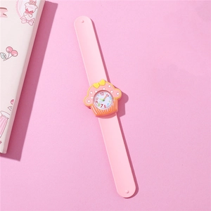 Close-up of pink kids slap watch featuring a 3D cupcake design and silicone wristband