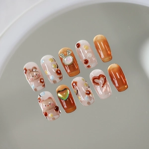 Handmade brown and white 3D bear press-on nails with cat-eye effect and heart embossed details