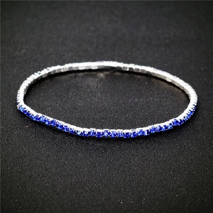 Macro shot of 2.0mm elastic bridal bracelet with single-row blue rhinestones in silver