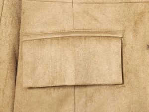 Detailed macro view of khaki suede fabric and pocket flap stitching on slim-fit blazer