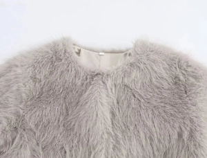 Close-up of premium light grey faux fur texture on a luxury short jacket collar