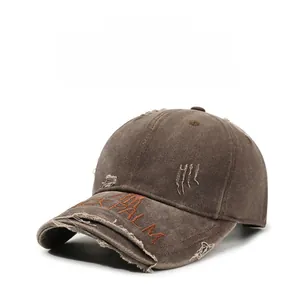 Detail of distressed brim and orange PALM embroidery on retro washed cotton baseball cap