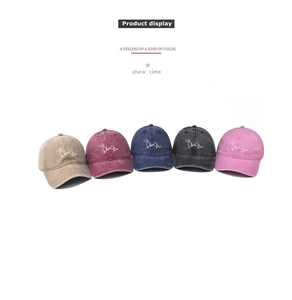 Detail view of five washed cotton baseball caps with minimalist dachshund puppy embroidery