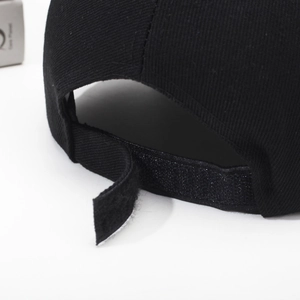 Classic black cotton baseball cap with adjustable Velcro strap detail and twill texture