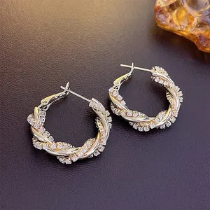 Golden twisted rope hoop earrings with zircon paving and secure latch back closure