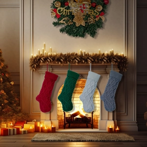 Set of 4 knitted Christmas stockings in red, green, grey, and blue hanging by a fireplace