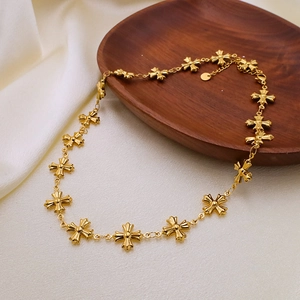 Detail shot of golden Byzantine style necklace with cross pendants on satin