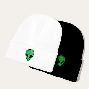 Unisex winter knit beanies in black and white featuring green alien embroidery
