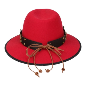 Detail of red wide-brimmed fedora with black leather belt and metal rivet accents