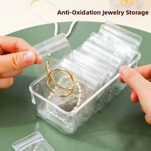 Macro detail of transparent PVC jewelry storage bag inside a clear rectangular organizer box