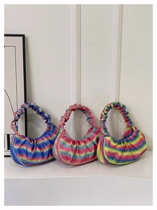 Detailed view of rainbow gradient pleated crescent bags in three vibrant color options