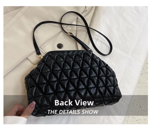 Detailed back view of the black quilted crossbody bag with luxury shell clasp and gold chain