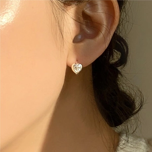Elegant 925 sterling silver heart earrings with sparkling cubic zirconia on ear