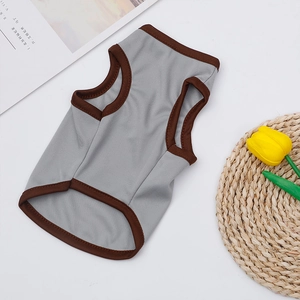 Close-up of gray breathable mesh pet vest with durable brown ribbed edges for summer comfort