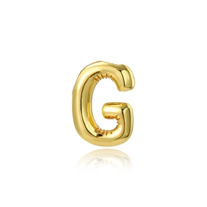 Close-up of golden balloon-style letter G pendant with high polished 18K gold finish