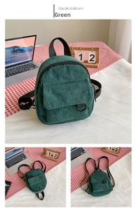 Detail view of corduroy backpack with adjustable black straps and front flap pocket