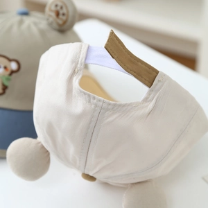 Detail of adjustable velcro strap on soft cotton baby cap with neat stitching quality