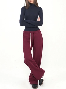 Women's low waist drawstring wide leg sweatpants with navy turtleneck sweater