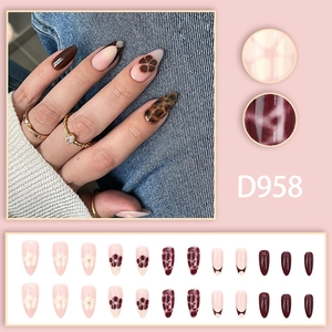Almond leopard print press-on nails with dark brown French tips and flower designs