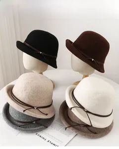 Detailed view of stackable wool felt bucket hats in five colors with leather cord and heart charm