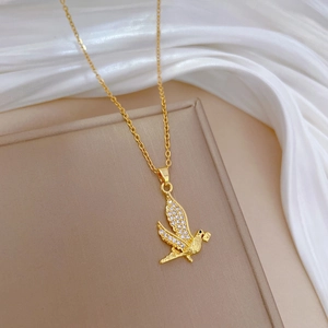 Elegant gold titanium steel necklace featuring a sparkling crystal-encrusted swallow pendant
