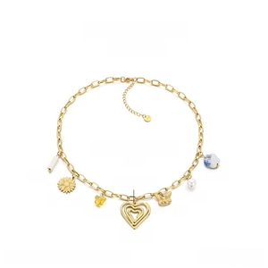 Detailed view of stainless steel gold chain with heart, butterfly and daisy charms