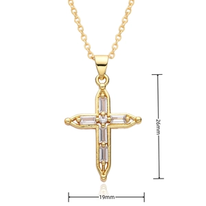 Macro detail of gold cross pendant necklace showing dimensions 26mm by 19mm