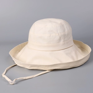 Close-up of beige cotton linen sun hat with adjustable wind strap and clear toggle