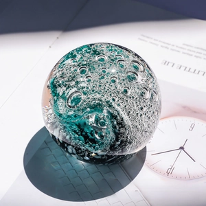 Macro shot of glass crystal ball featuring ocean wave bubble design on a desktop