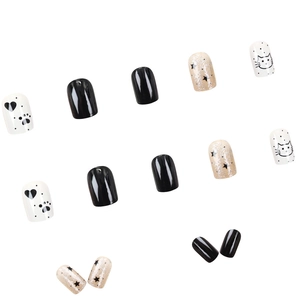 Short press-on nails set with black finish, silver glitter stars, and cat pattern designs