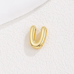 Detailed close-up of a gold-plated U-shaped alphabet charm for DIY bracelets and watches