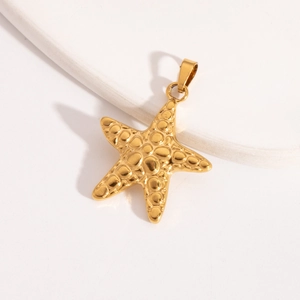 Detailed view of a gold starfish pendant featuring textured surface and metal jump ring