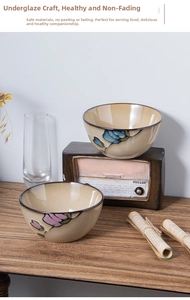 Detail of hand-painted floral ceramic bowls with Japanese kiln glaze finish on wood table