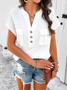 Detail of white V-neck short sleeve shirt with buttoned front and textured chest pockets