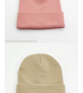 Detailed knit texture of pink and beige double-layer warm beanies for winter