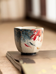 Macro detail of hand-painted koi fish and golden floral patterns on a hexagonal ceramic cup