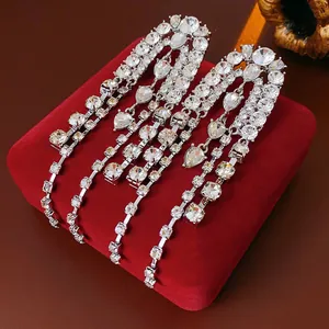 Sparkling waterdrop tassel earrings with clear crystals on a red velvet jewelry box