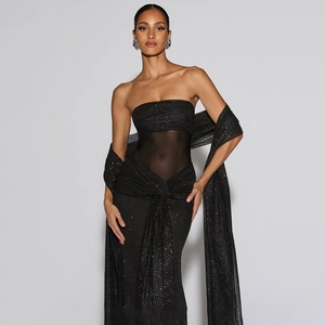 Detail of elegant black strapless evening dress with glitter fabric and sheer waist panel